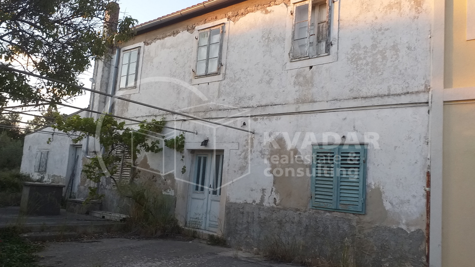 A detached stone house near the sea.