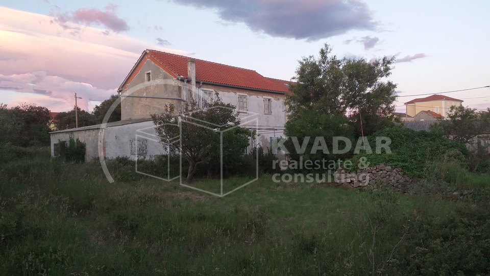 A detached stone house near the sea.