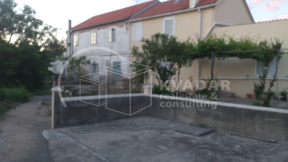 A detached stone house near the sea.