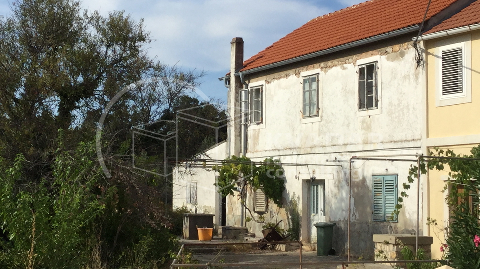 A detached stone house near the sea.