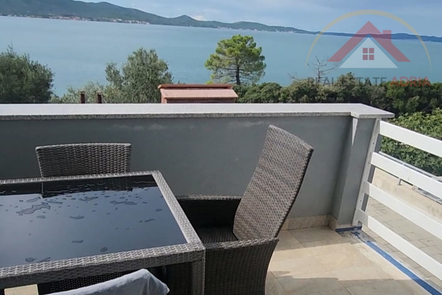 A detached house for sale, first row to the sea and the beach, with three apartments and a view of the sea, in the village of Sv. Petar na Moru, Zadar County